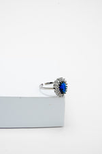 Silver-tone adjustable ring with a blue stone
