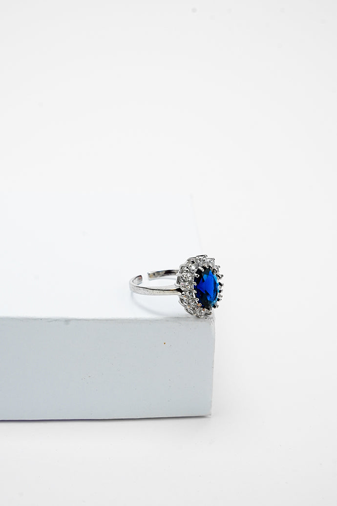 Silver-tone adjustable ring with a blue stone