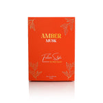 Amber Musk perfume orange-red box with gold leaf design, front view