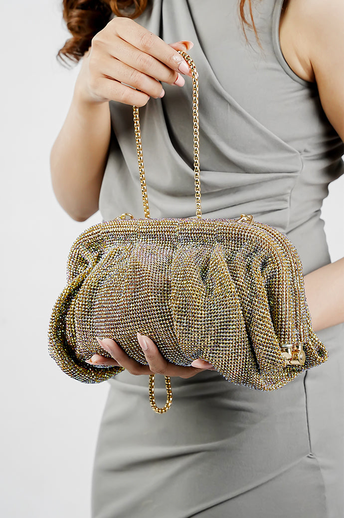 Shimmer Benedetta rhinestone clutch bag held at the waist with a grey dress