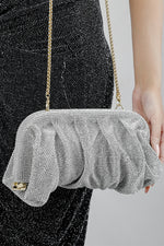 Silver rhinestone clutch bag for women carried by the matching chain