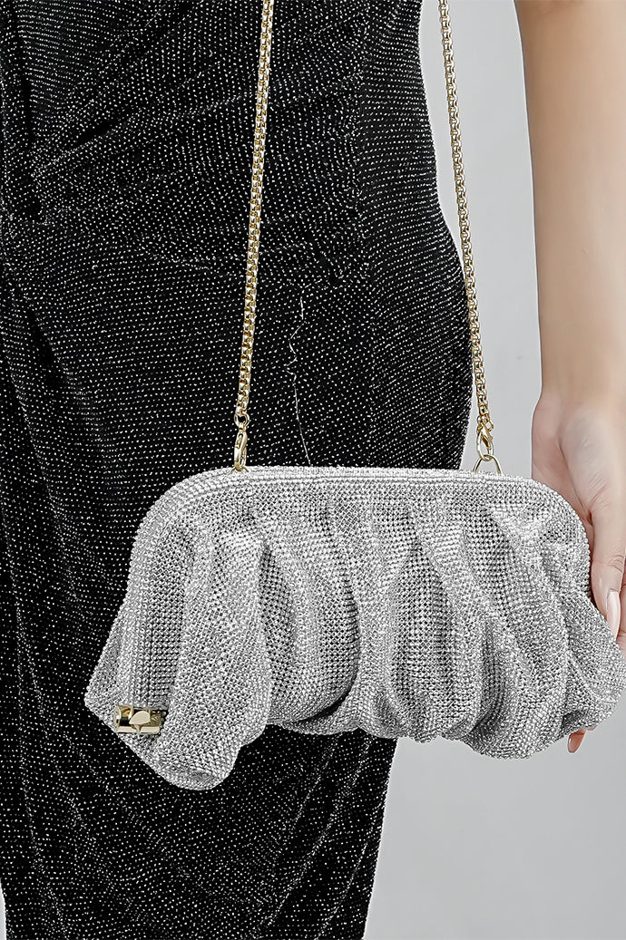 Silver Benedetta clutch bag held at the side, close-up of the mesh