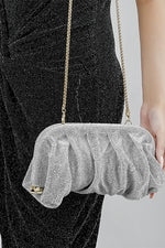 Silver Benedetta clutch bag held at the side, close-up of the mesh