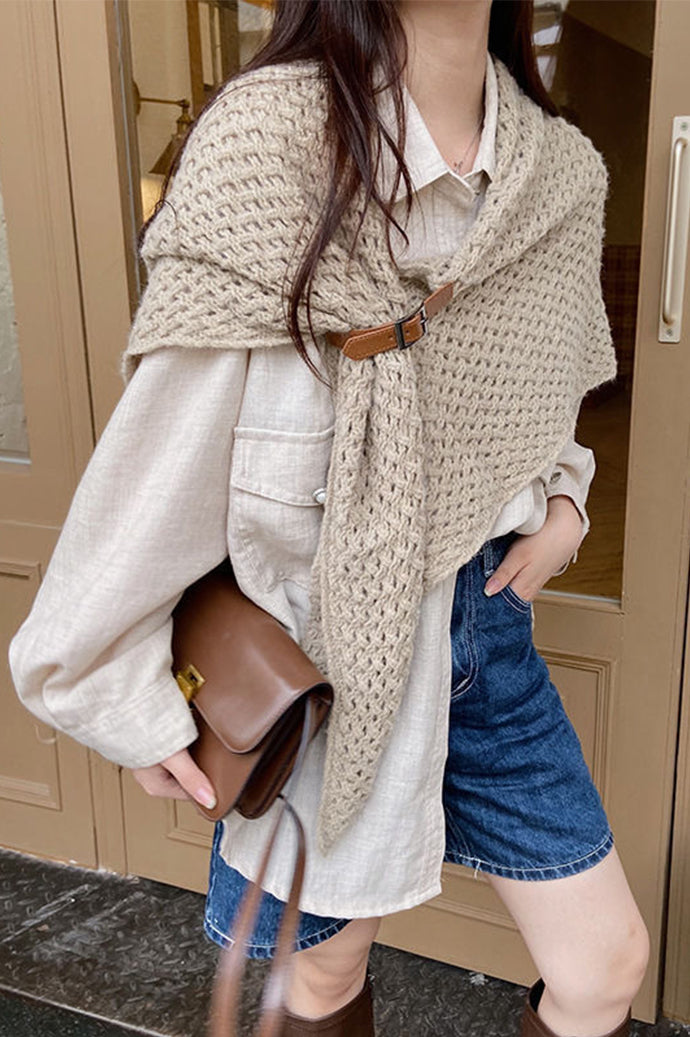 Woman wearing the Bohemian winter knit cape in taupe with a toggle fastener over a white shirt, Future Style Pakistan