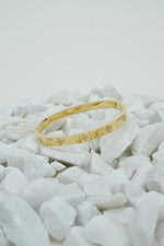 Gold clove stone bangle for women on white stones