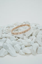 Rose gold clove stone bangle for women on white stones