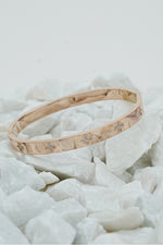 Rose gold clove stone bangle with stone accents on white stones