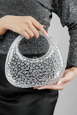 Clear textured clutch bag for women held by the handle, front view, Future Style Pakistan