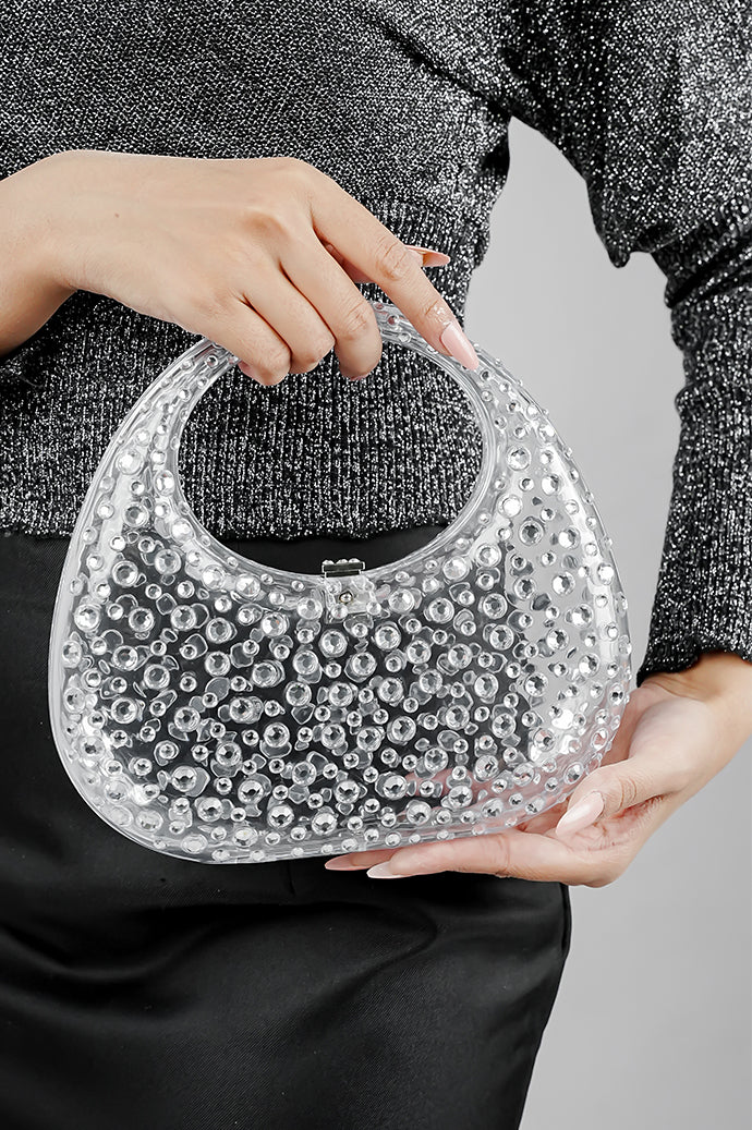 Clear textured clutch bag for women held by the handle, front view, Future Style Pakistan