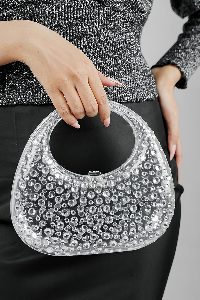 Clear clutch bag for women held at the waist with a black skirt
