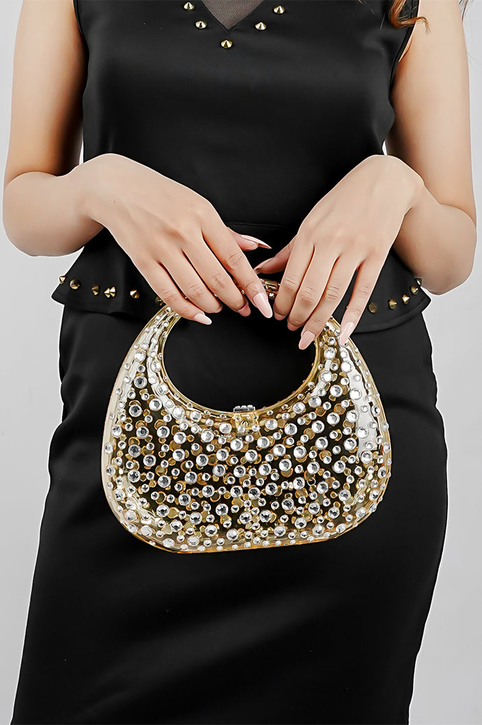 Gold clutch bag held in front, showing the textured finish