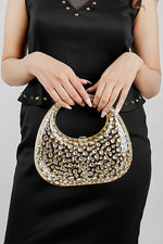 Gold clutch bag held in front, showing the textured finish