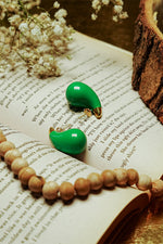 Close-up of colourful earrings for women with gold-tone setting