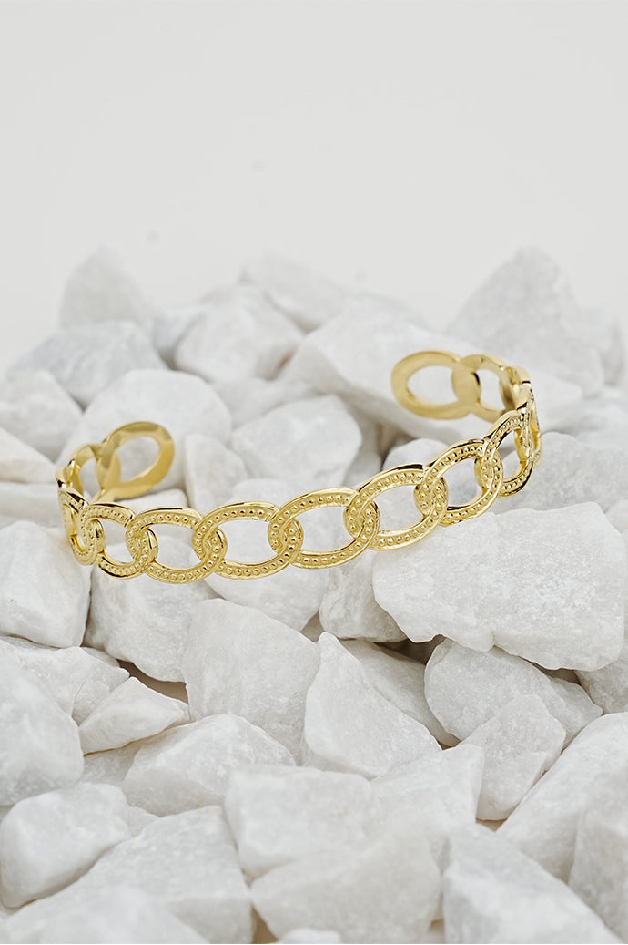Gold open style chain-link bangle on white stones