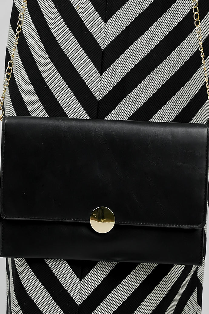 Close-up of the gold emblem on the black Envelope Bag