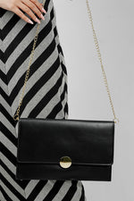Black Envelope Bag with gold chain worn on the shoulder