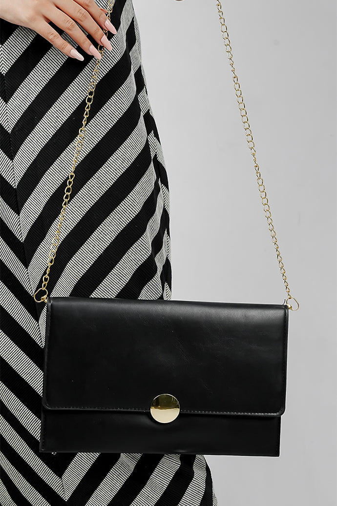 Black Envelope Bag with gold chain worn on the shoulder