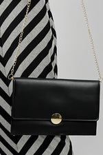 Black Envelope Bag with magnetic closure and gold emblem, side view