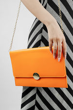 Orange Envelope Bag with gold emblem and magnetic closure