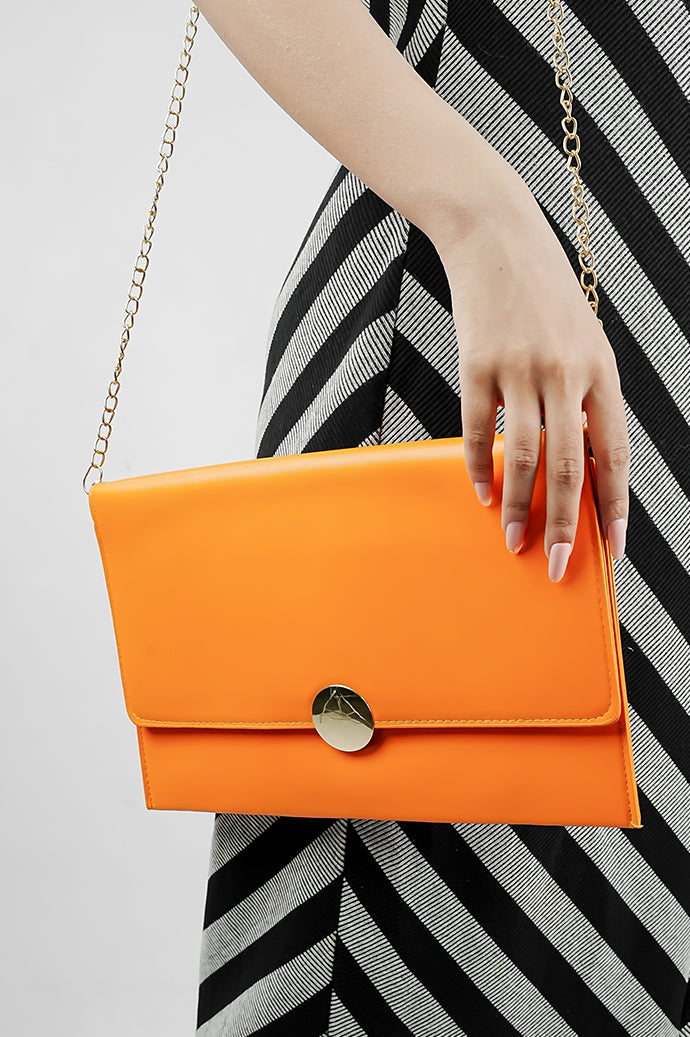 Orange Envelope Bag with gold emblem and magnetic closure