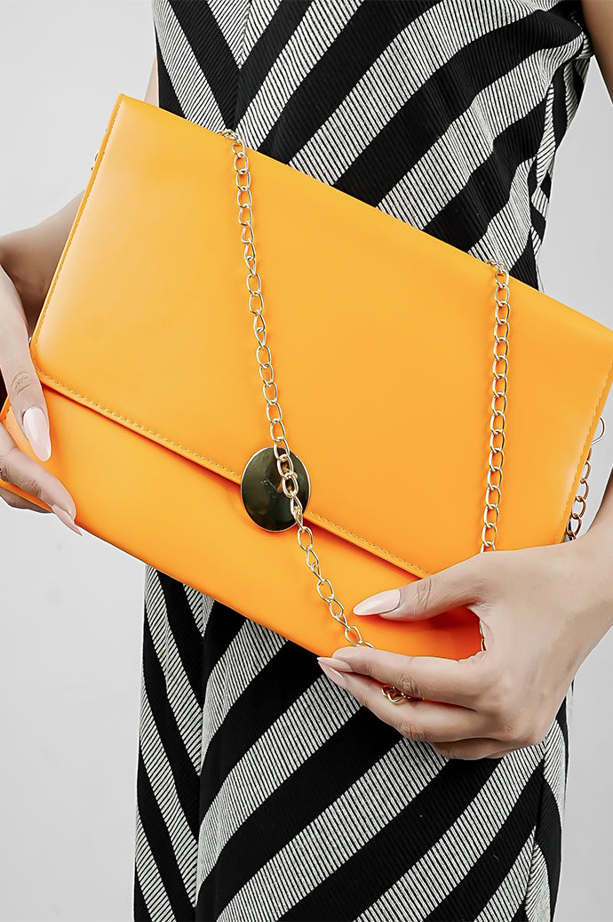 Orange Envelope Bag with gold chain carried on the shoulder