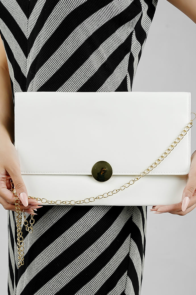 White Envelope Bag styled with a black and white striped dress