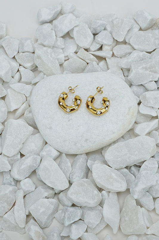Half crescent hoop earrings with pearl-style beads in gold tone