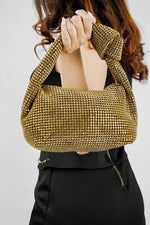 Close-up of the knot handle on the Hubo gold clutch