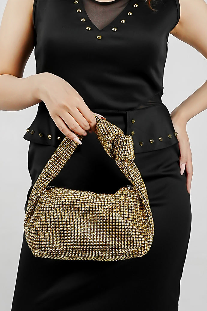 Hubo gold sparkling clutch with knotted handle, side view on a model