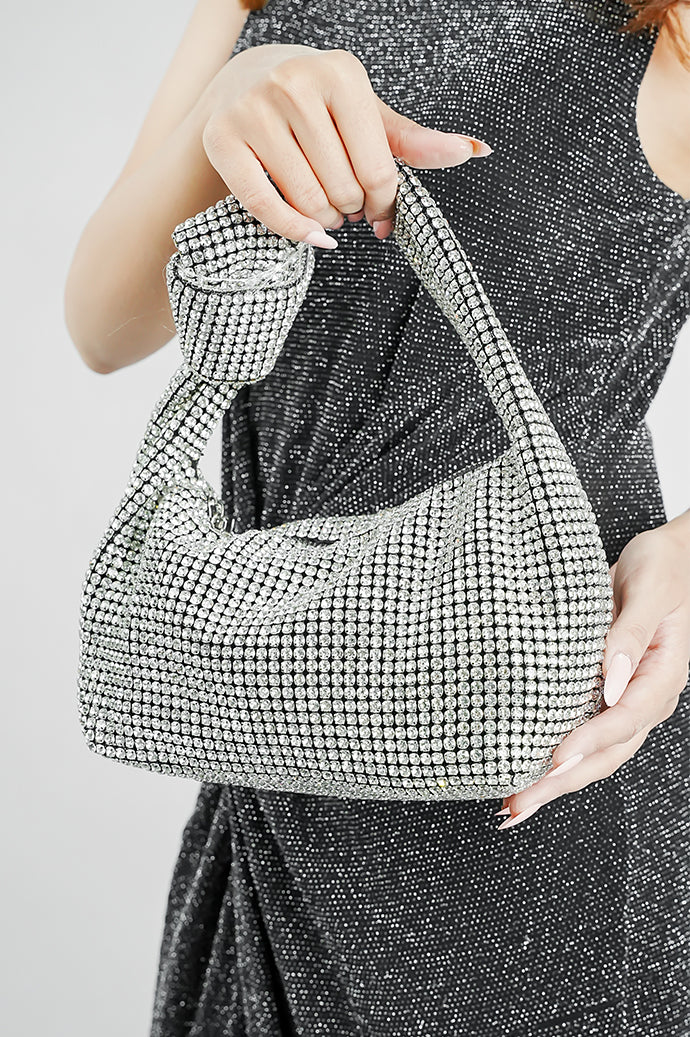 Hubo silver clutch carried by its knotted handle