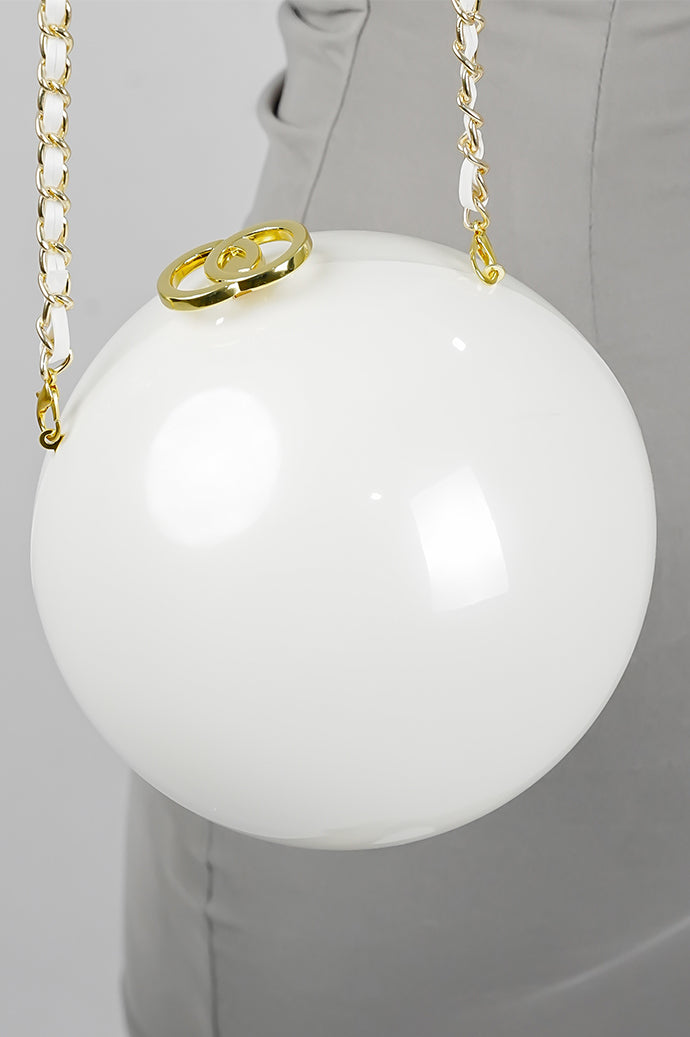 Luna white globe clutch with golden clasp and chain, front view
