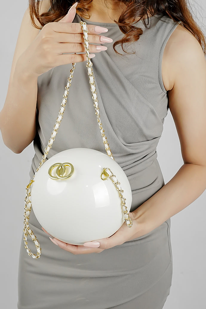 Luna white pearl globe clutch with gold chain styled with a grey dress