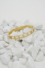 Gold open clove bangle for women with cut-out design