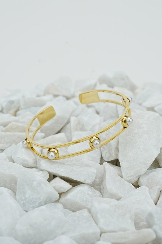 Gold open pearl bangle with double band design on white stones