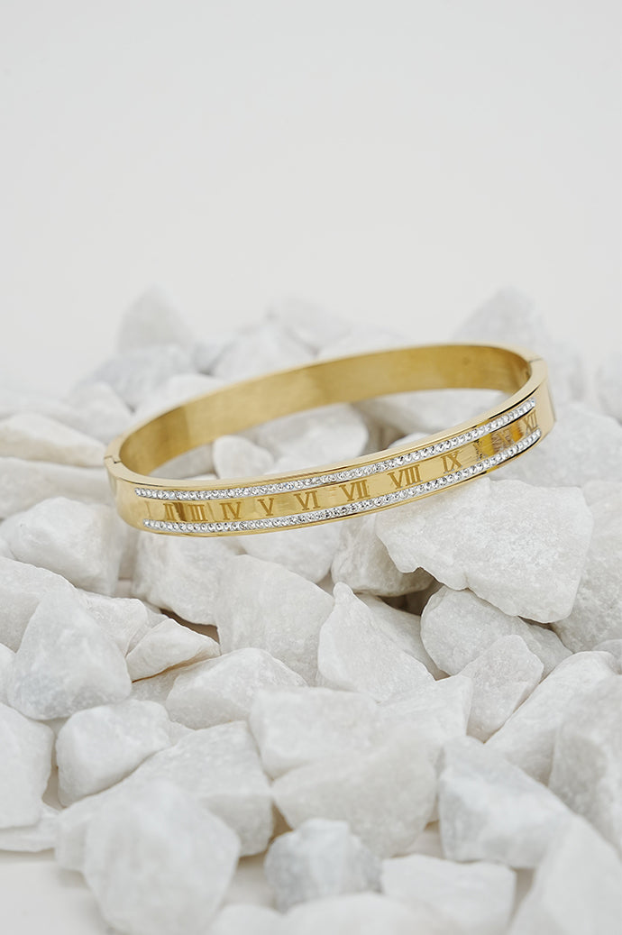 Gold Roman rhinestone bangle with engraved numerals on white stones