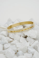 Gold Roman rhinestone bangle with engraved numerals on white stones