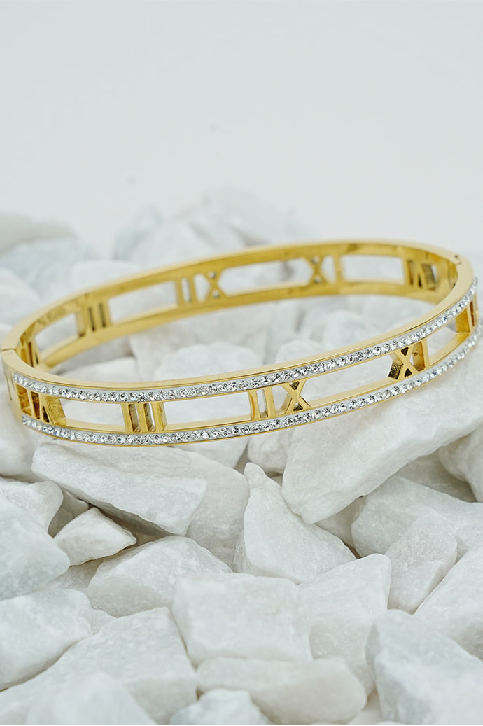 Gold Roman rhinestone open bangle with cut-out numerals on white stones