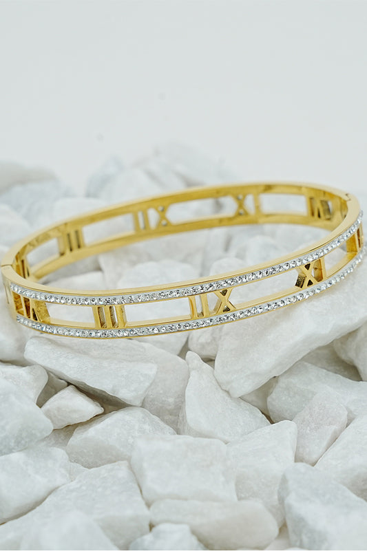 Gold Roman rhinestone open bangle with cut-out numerals on white stones