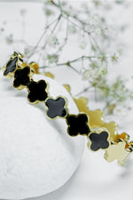 Gold bangle with black enamel clover design, Roman style close bangle