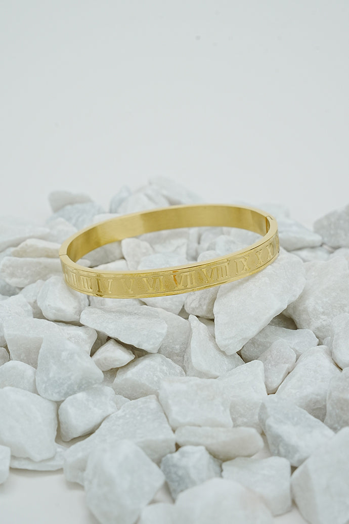 Gold Roman style close bangle for women on white stones