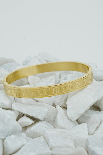 Gold Roman style close bangle with engraved Roman numerals on white stones