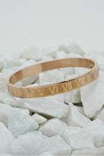 Rose gold Roman style close bangle with engraved numerals on white stones