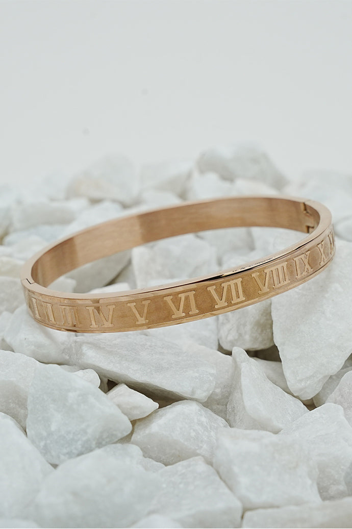 Rose gold Roman style close bangle with engraved numerals on white stones