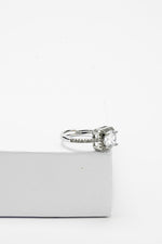 Silver-tone solitaire ring with a single stone