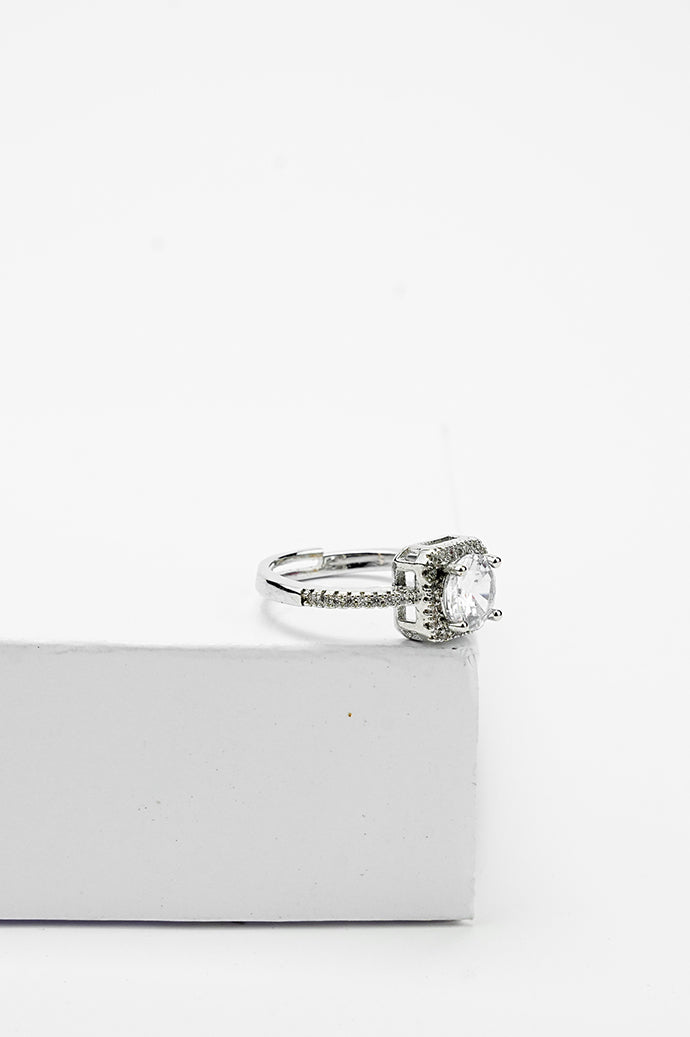 Silver-tone solitaire ring with a single stone