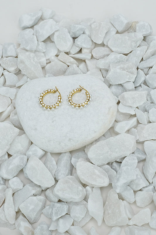 Small full hoop earrings with a pearl-style bead in gold tone