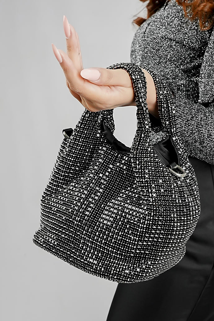 Stellar black crystal bucket bag hanging from the arm, side view