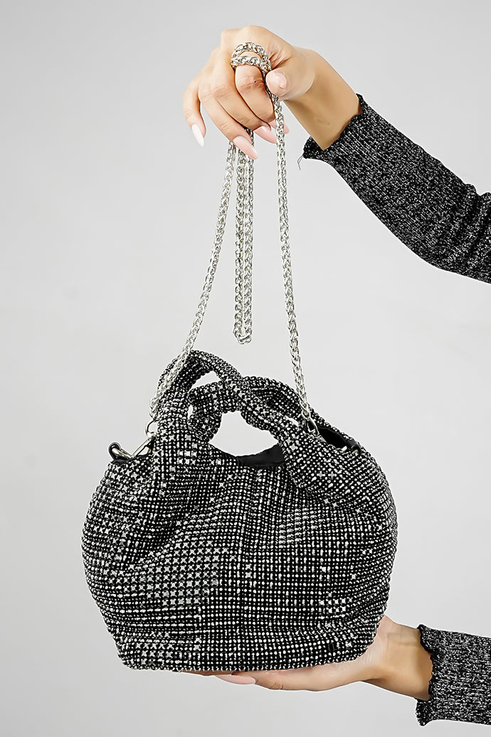 Black crystal Stellar bucket bag held by its chain strap