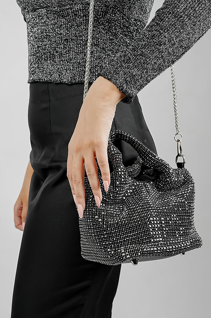 Stellar black crystal bucket bag worn on the shoulder with chain, side view