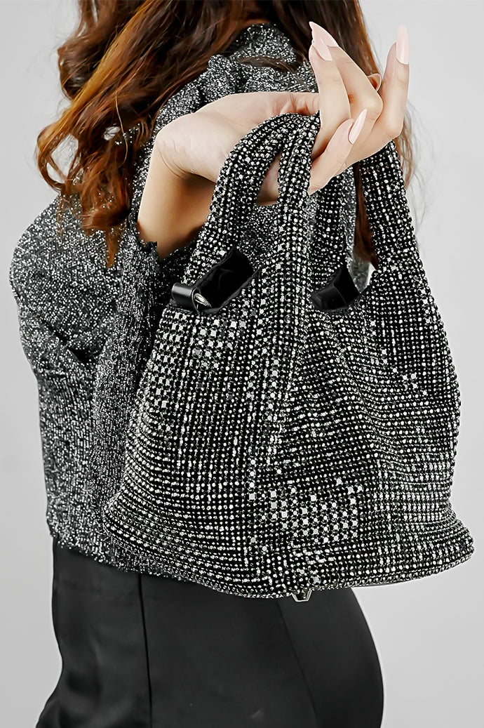 Stellar black crystal bucket bag held in hand, close view